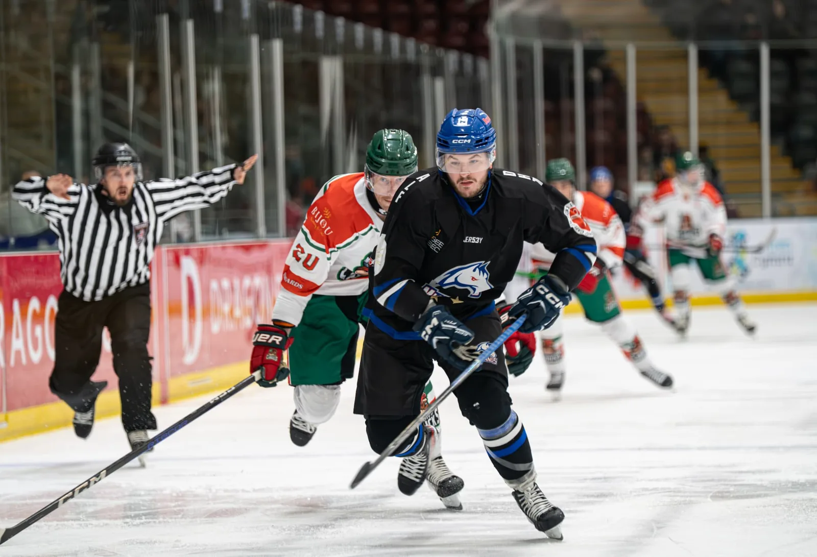 A Canucks player carrying the puck in a game on home ice
